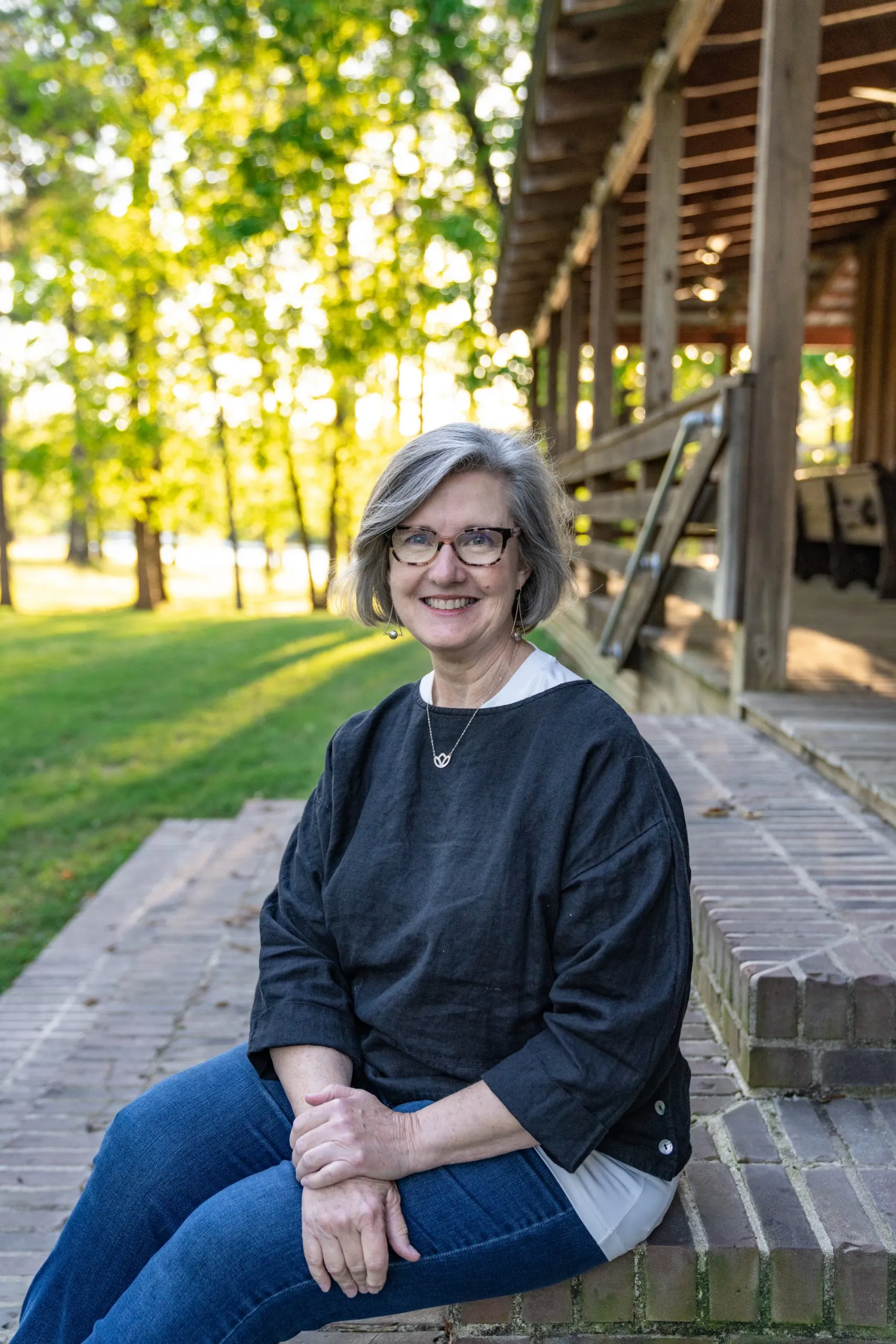 Lauren Zumwalt sitting on the stairs at Rasberry Greene, home of Rahoma Grains.